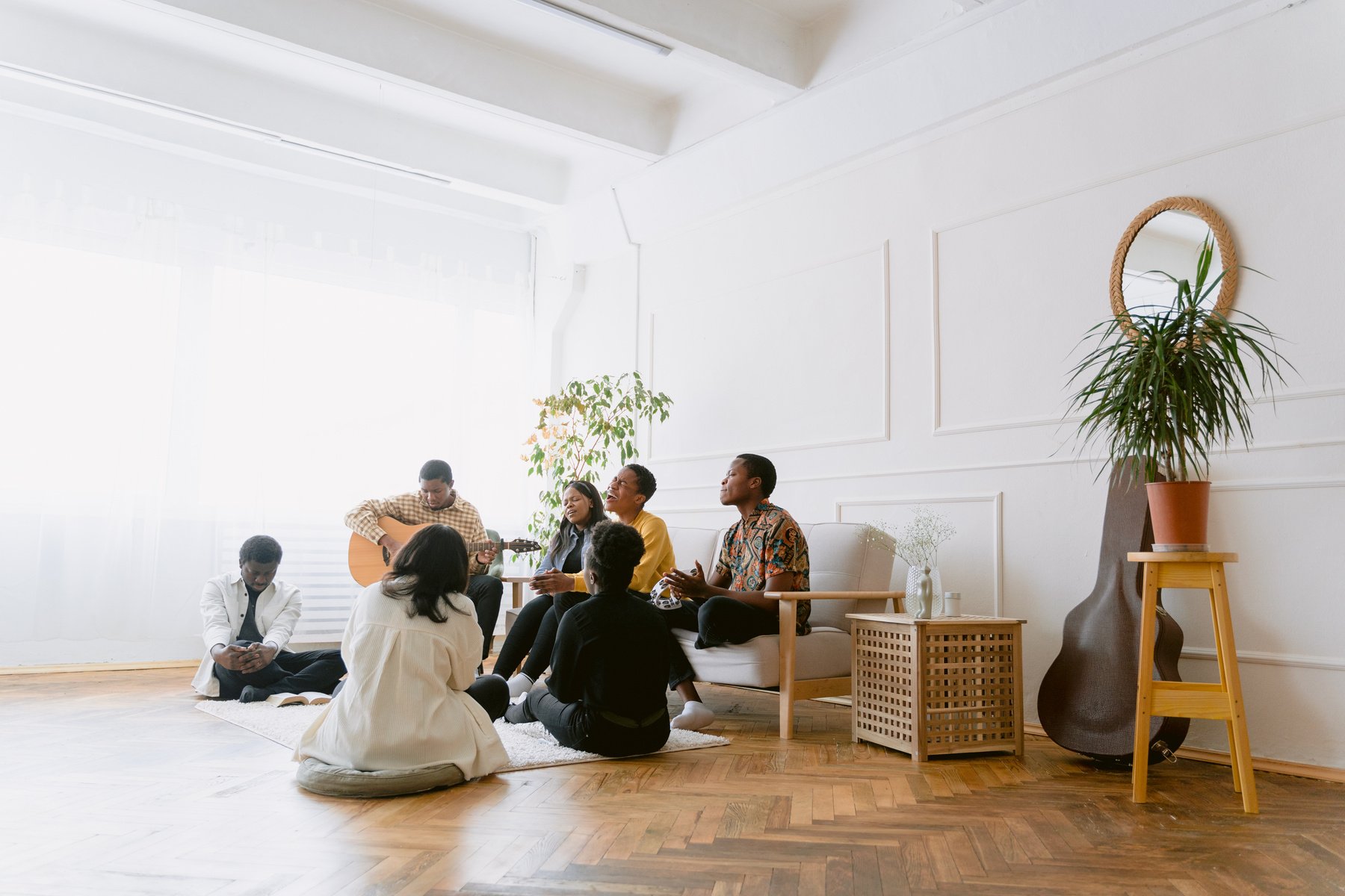 Youth Gathered Together Sitting and Singing Worship Songs 